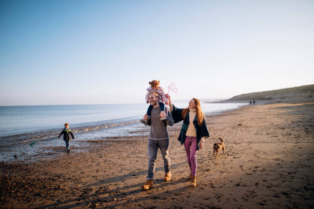 familie op het strand in de winter - happy couple cold stockfoto's en -beelden