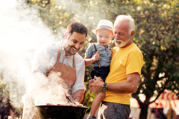 Family on vacation having barbecue party Barbecue time.Happy big family make barbecue in their garden. multi generation family stock pictures, royalty-free photos & images