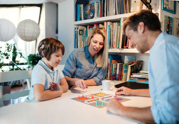 Family Playing Board Game Family playing board game at home. play game stock pictures, royalty-free photos & images