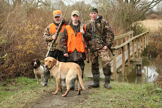 Family pose during hunting trip. stock photo