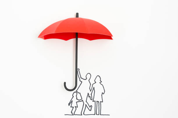 Family protection insurance concept using red umbrella stock photo