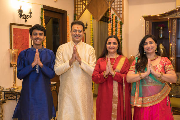 Family standing together in tradional wear doing namaste Family standing together in tradional wear doing namaste in greeting pose namaste greeting stock pictures, royalty-free photos & images
