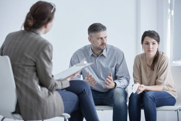 Family therapist and unhappy couple stock photo