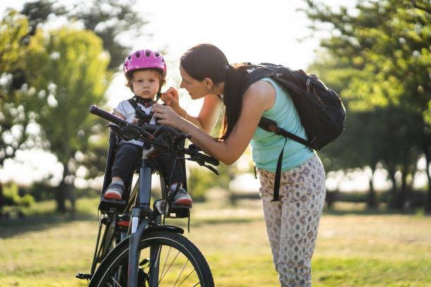 Family time, mother and daughter Cycling through the park stock photo