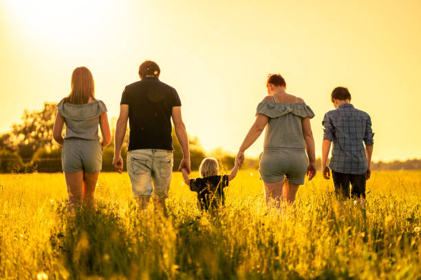 family-walking-together-on-grass-field-against-sky-picture