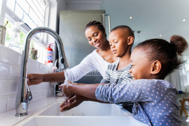Family washing their hands together. stock photo