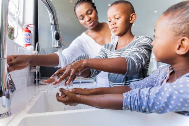 Family washing their hands together. stock photo