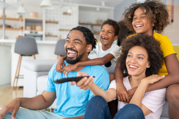 Family watching television stock photo