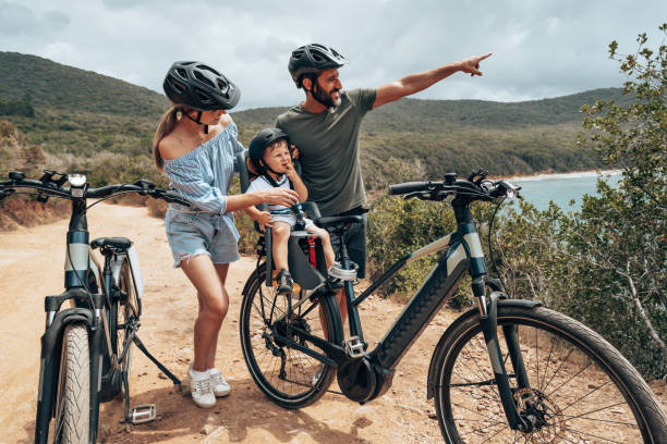 family with bike in a country tour stock photo
