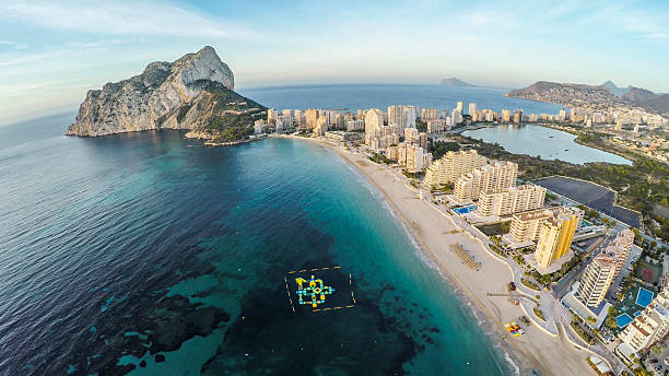 Famous Mediterranean Resort Calpe in Spain / STUNNING VIDEO ALSO Aerial view of sunny morning on the beach of Calpe, Calp. Penon de Ifach also on the photo. calpe stock pictures, royalty-free photos & images