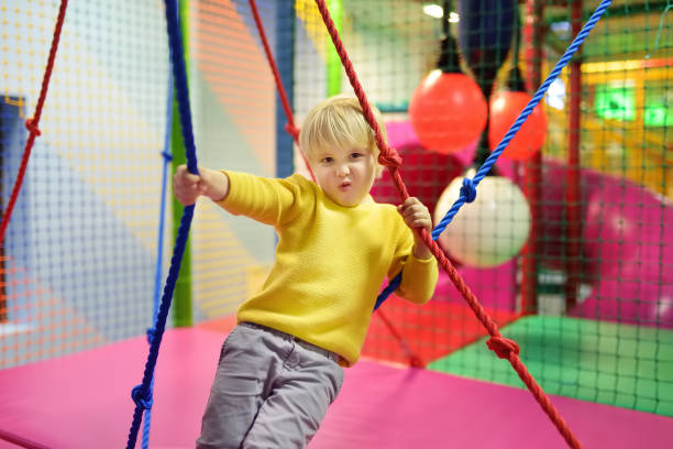Fanny little boy after activity on trampoline. Child playing on indoor playground. Fanny little boy after activity on trampoline. Child playing on indoor playground. Kid jumping on trampoline indoor playground stock pictures, royalty-free photos & images