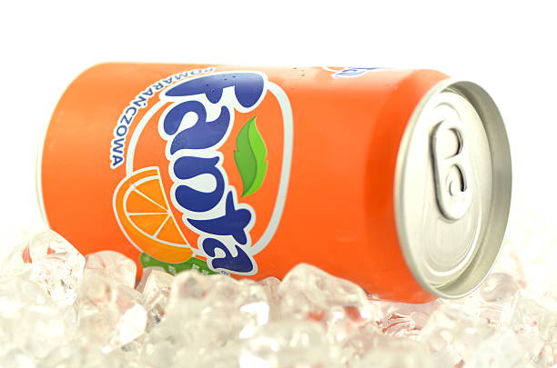 Fanta drink in can on ice isolated on white background stock photo