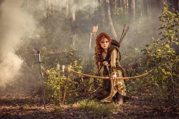 Fantasy medieval woman hunting in mystery forest stock photo
