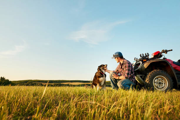 Farmer with his pet dog in the farm stock photo