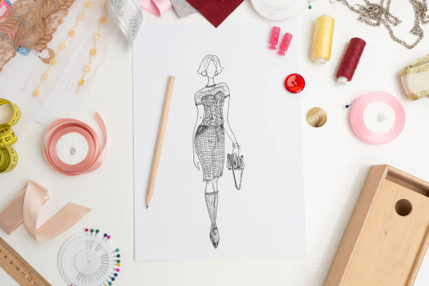 Fashion design. Sketches of stylish women's clothing. Designer drawings of dresses on paper. stock photo