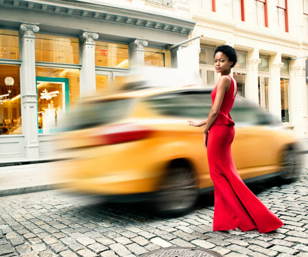 Fashion in New York City Woman wearing a red gown in Soho, New York high fashion model stock pictures, royalty-free photos & images