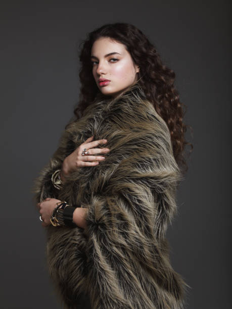 Fashion model in faux fur coat stock photo