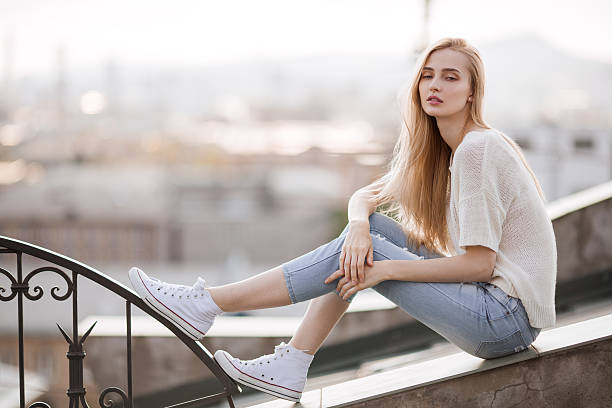 Fashion model. Summer look. Jeans, sneakers, sweater. stock photo