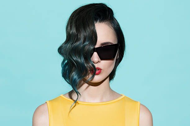 Fashion portrait of sensual stylish woman on a blue background. stock photo