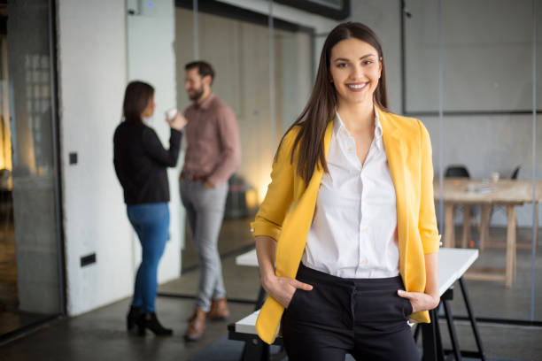 Fashionable businesswoman standing and looking at camera stock photo