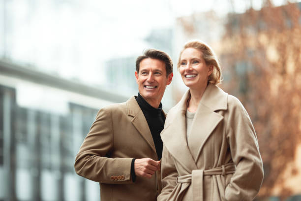 Fashionable couple Handsome couple is standing in the street and looking at the same spot in the distance. georgijevic frankfurt stock pictures, royalty-free photos & images