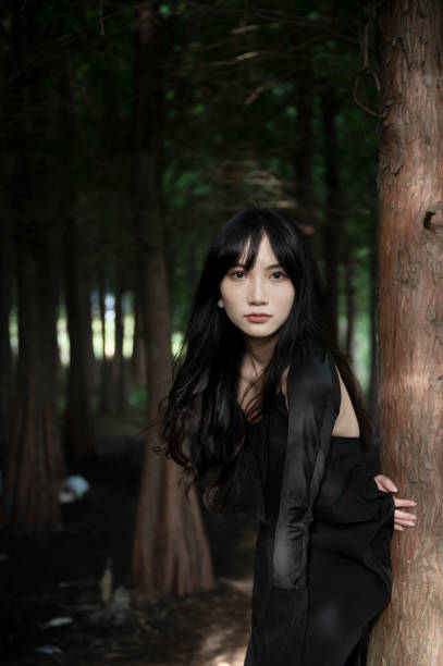 Fashionable girl in black in the woods stock photo