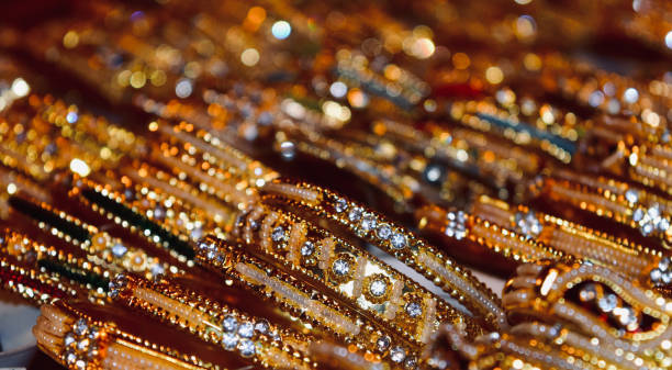 Fashionable golden bracelets around a shop Fashionable golden bracelets around a shop unique photo indian jewelry stock pictures, royalty-free photos & images