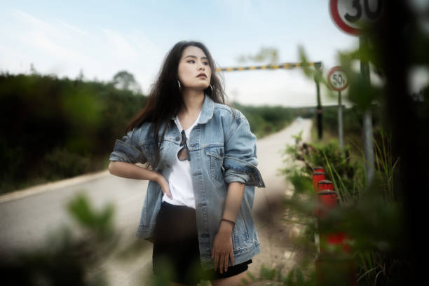 Fashionable women in jeans stood on the road stock photo