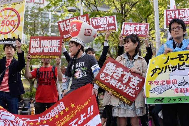 #fastfoodglobal Tokyo,  Japan - April 15, 2015: Fast food workers protesting against harsh working conditions and low wages, as part of the global fast food workers' strike. mcdonalds japan stock pictures, royalty-free photos & images