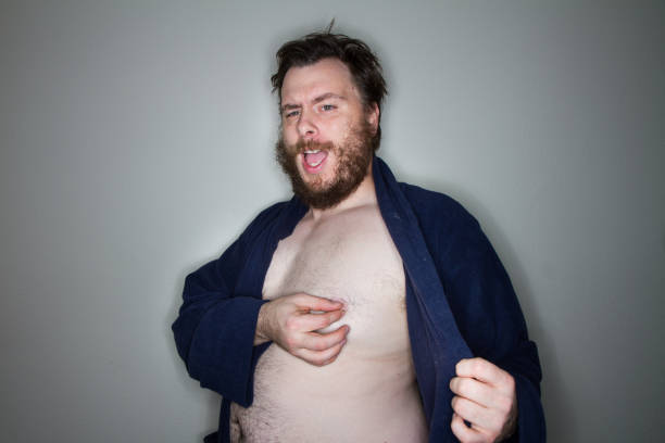fat man getting naked stock photo