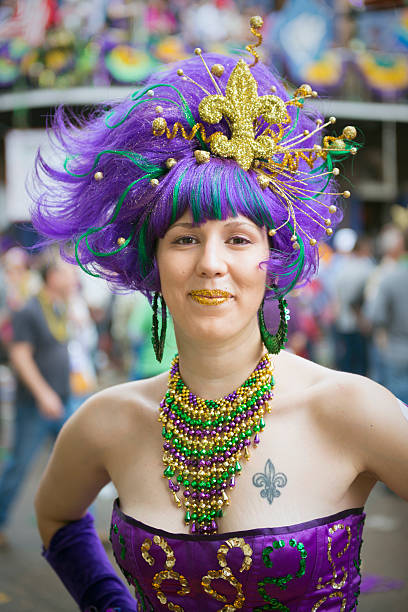 Fat Tuesday costume at Mardi Gras - New Orleans A young woman dressed up on Fat Tuesday on Bourbon Street in New Orleans, LA. The tattoo on her chest is a fleur-de-lis, the symbol of New Orleans. mardi gras women stock pictures, royalty-free photos & images