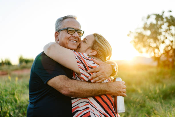 Father and daughter holding each other at sunset in the countryside Father and daughter holding each other at sunset in the countryside fathers day stock pictures, royalty-free photos & images