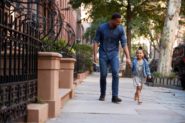 Father and daughter taking a walk down the street Father and daughter taking a walk down the street brooklyn new york stock pictures, royalty-free photos & images