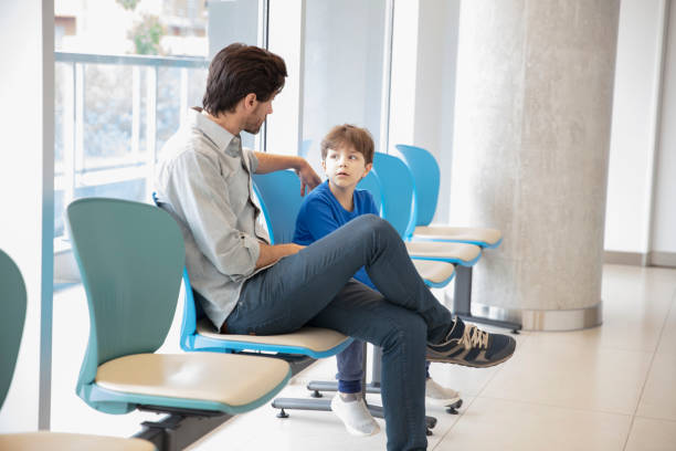 Father and son at waiting room stock photo