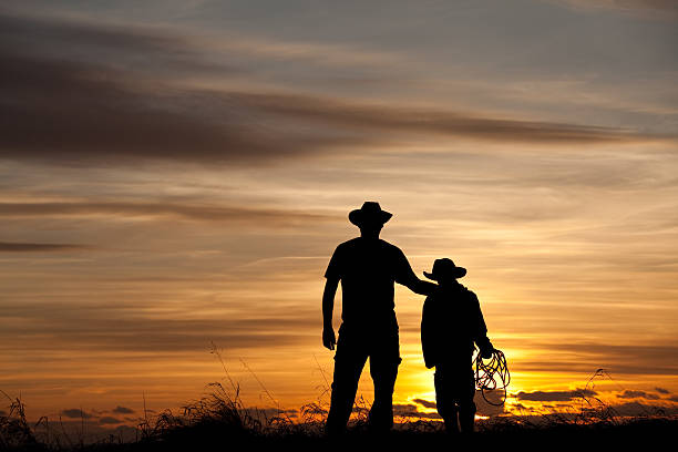 Father and Son Cowboy Silhouette stock photo