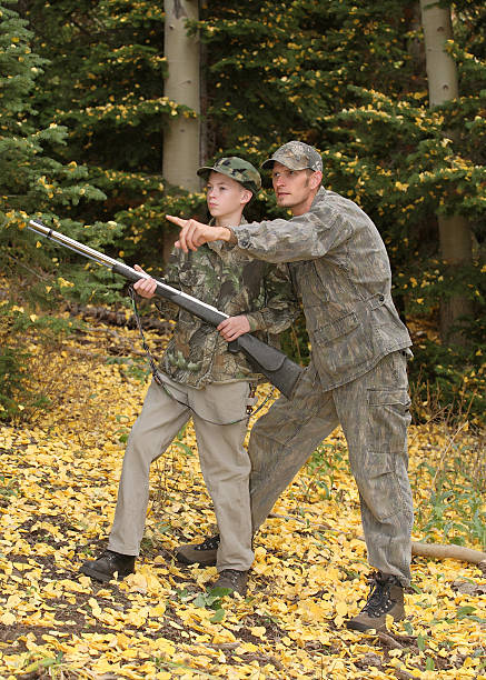 father and son hunting - youth hunting stock photos and pictures.
