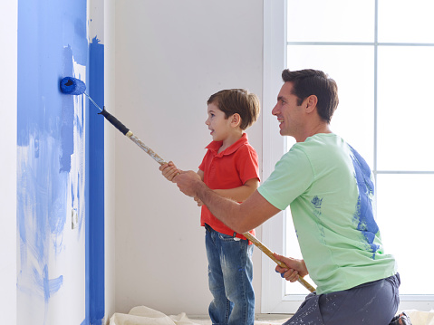 Father And Son Painting Wall Together Stock Photo More Pictures