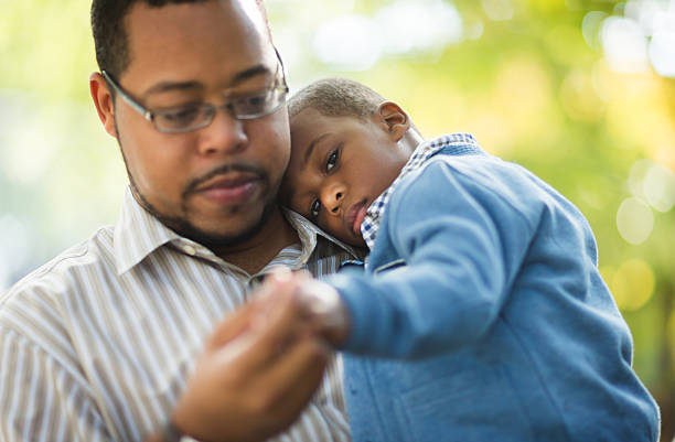 Father and Son A father holding his little boy.   grief stock pictures, royalty-free photos & images