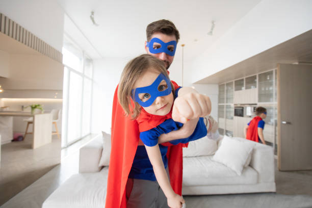 Father and son play superhero stock photo