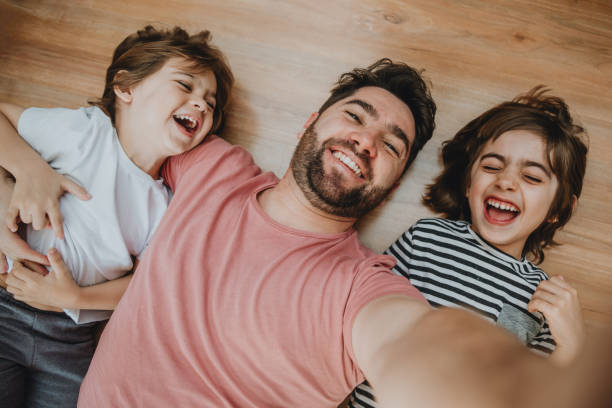 Father having fun with kids and making selfie at home Father having fun with kids and making selfie at home fathers day fathers day stock pictures, royalty-free photos & images