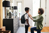 istock Father helping son get ready for school 1346794918