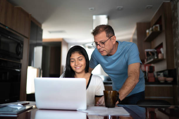 Father helping teenager with work or homework  homework stock pictures, royalty-free photos & images