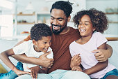 istock Father holding his children 1363574365