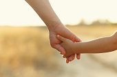 istock Father holds daughter by the hand 909399064