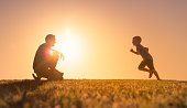 istock Father playing with his son in the park. 1327689473