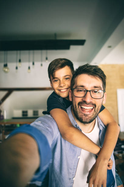 baba oğlu ile bir selfie alarak - selfie stok fotoğraflar ve resimler
