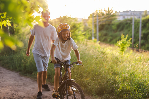 Father Teaching His Son How To Ride A Bicycle Stock Photo - Download ...