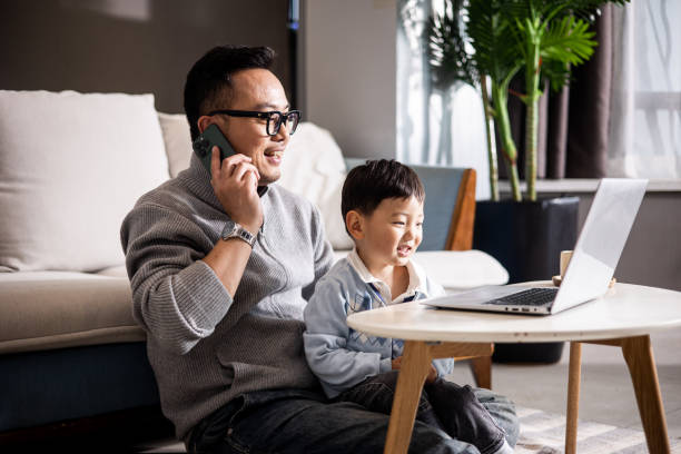 Father with his son working together at home stock photo