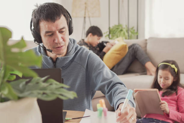 Father working from home with children. Homeschooling, stay home, social distancing during covid pandemic , freelance job, new normal concept stock photo