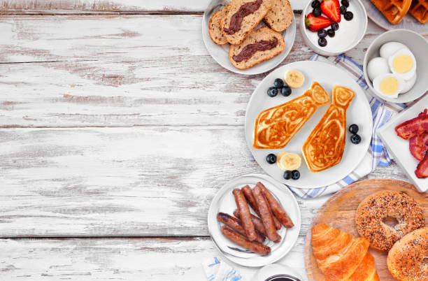 Fathers Day brunch side border. Top view on a white wood background. Fathers Day brunch side border. Top view on a white wood background. Tie pancakes, mustache toast and a variety of dad themed food. fathers day stock pictures, royalty-free photos & images